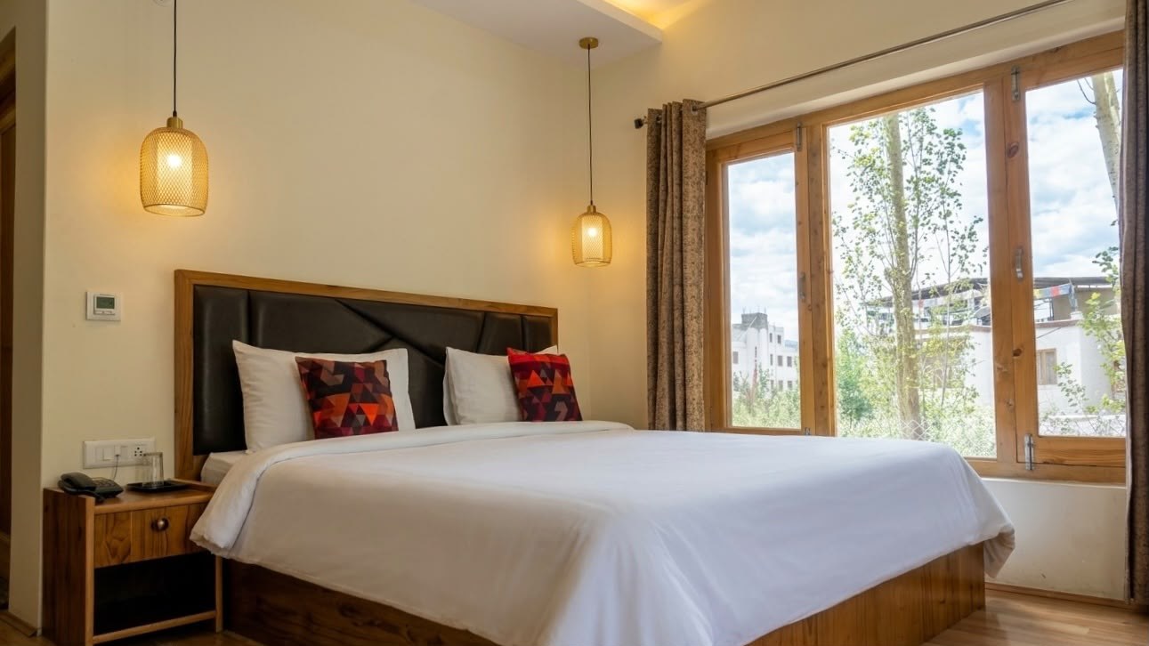 Standard double room with a queen bed and large windows